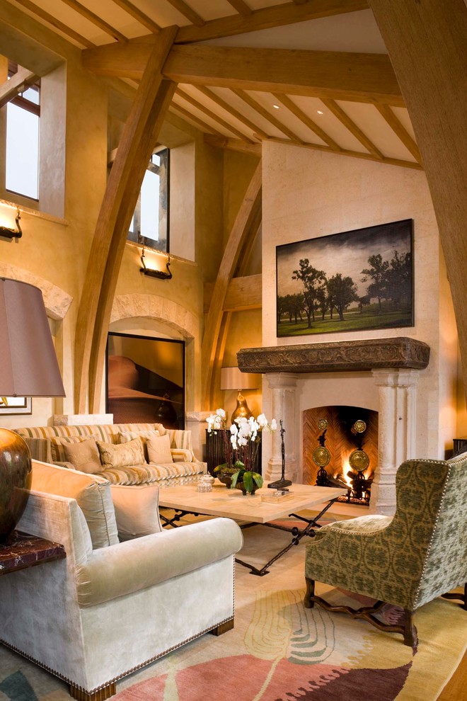 Großes, Repräsentatives, Fernseherloses, Offenes Mediterranes Wohnzimmer mit beiger Wandfarbe, braunem Holzboden, Kamin und Kaminumrandung aus Stein in Denver