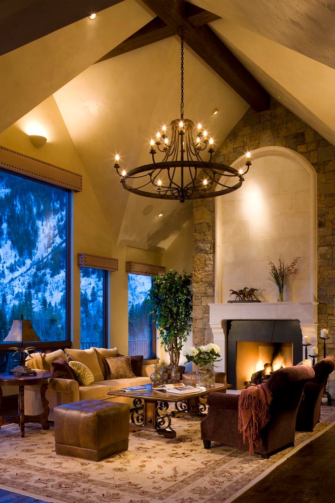 Photo of a large rustic formal enclosed living room in Denver with a standard fireplace, beige walls, dark hardwood flooring, a stone fireplace surround, no tv and brown floors.