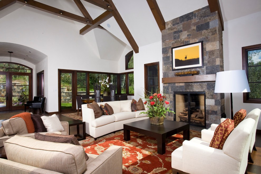 Photo of a contemporary living room in Denver with a stone fireplace surround.