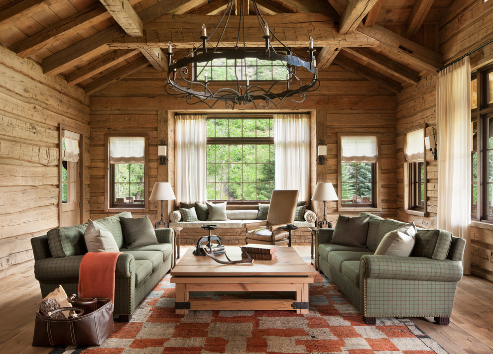 Large mountain style formal and enclosed light wood floor living room photo in Denver with brown walls