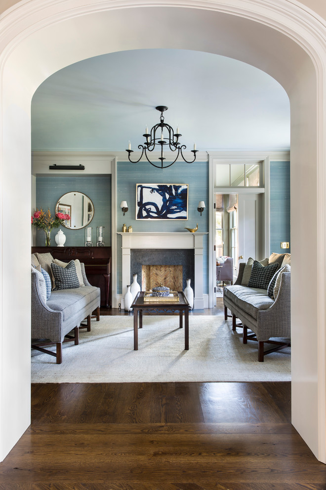 Living room - mid-sized transitional formal and enclosed dark wood floor and brown floor living room idea in San Francisco with blue walls, a standard fireplace and a plaster fireplace