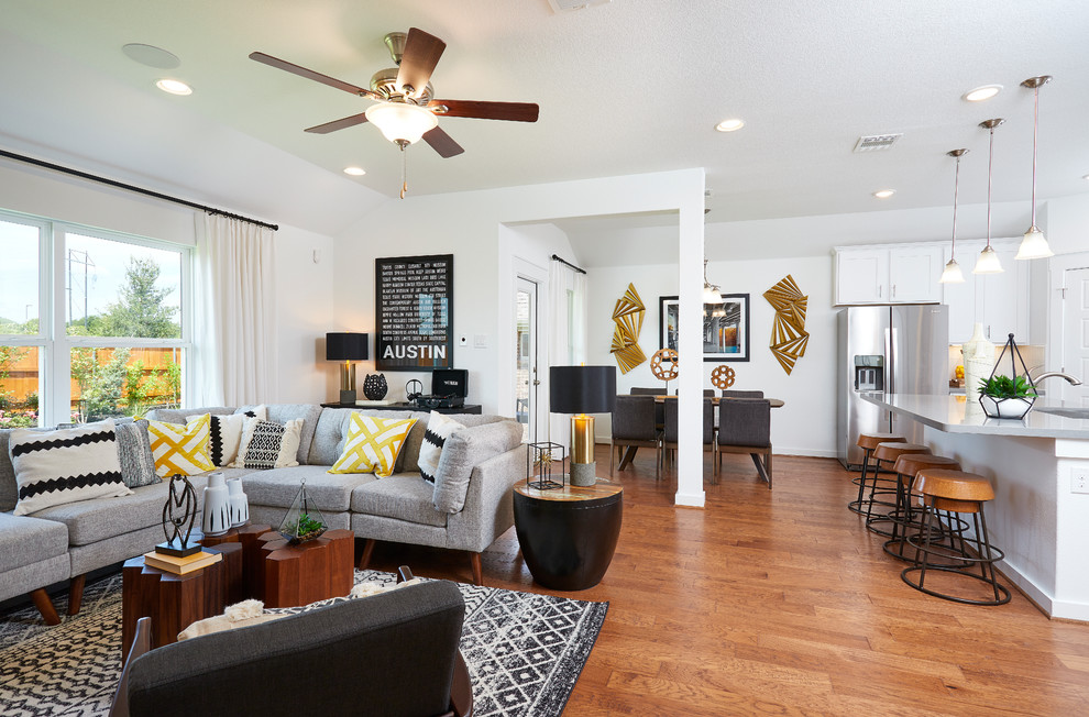 Medium sized contemporary open plan living room in Austin with white walls, medium hardwood flooring and brown floors.