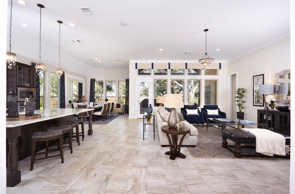Large transitional open concept limestone floor and beige floor living room photo in Austin with beige walls and no fireplace
