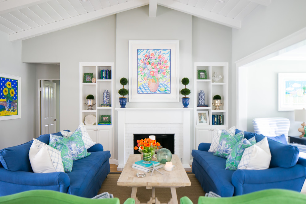 Photo of a coastal open plan living room in San Diego with grey walls, a standard fireplace and no tv.