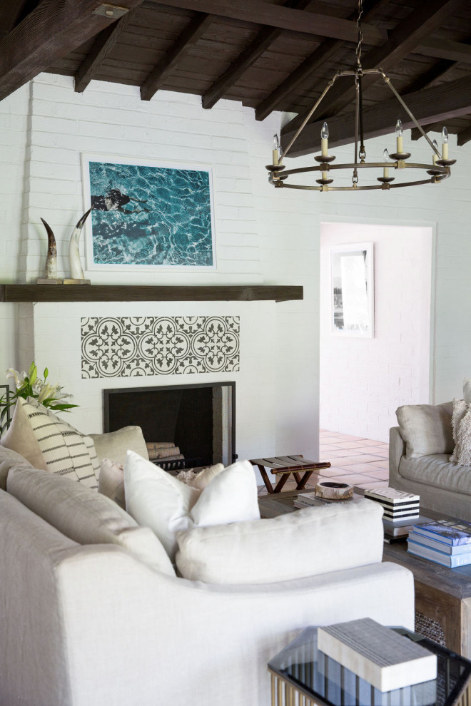 Inspiration for a mediterranean formal and open concept exposed beam, wood ceiling and shiplap wall living room remodel in Los Angeles with white walls, a standard fireplace and no tv