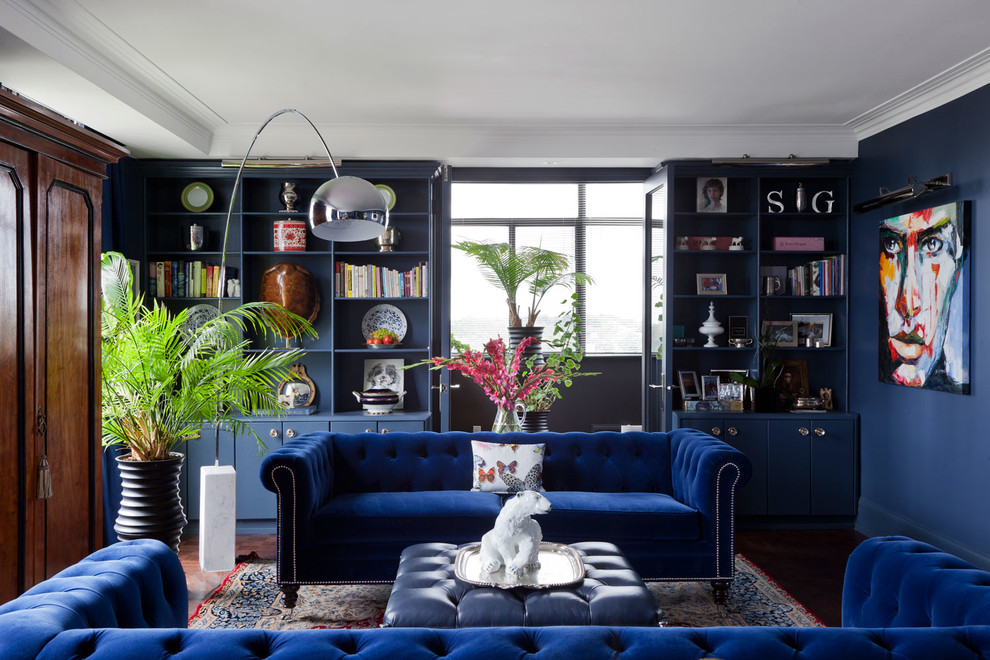 Idee per un soggiorno tradizionale di medie dimensioni e aperto con libreria, pareti blu e pavimento in legno massello medio