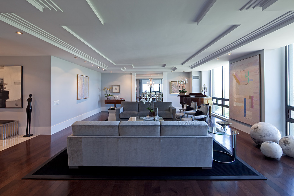 Пример оригинального дизайна: гостиная комната в современном стиле с серыми стенами