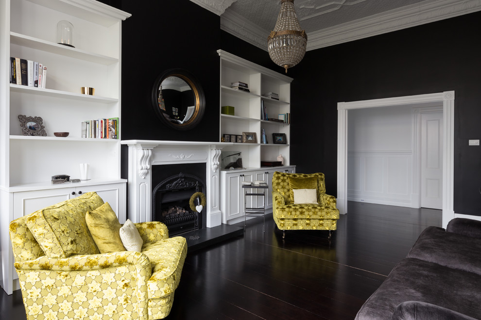 Foto de salón clásico renovado sin televisor con paredes negras, suelo de madera oscura y todas las chimeneas