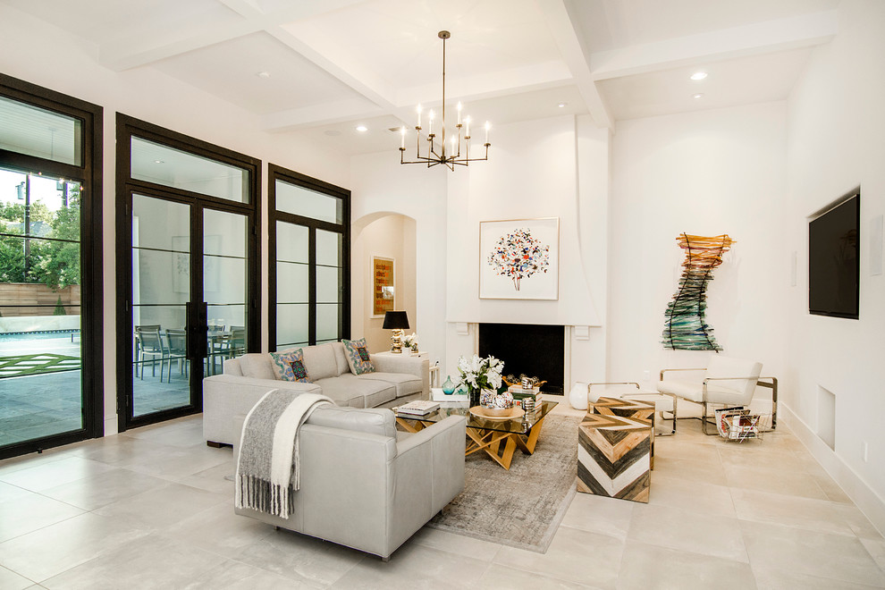 This is an example of a mediterranean formal living room in Dallas with beige walls, travertine flooring, a standard fireplace, a plastered fireplace surround and a wall mounted tv.