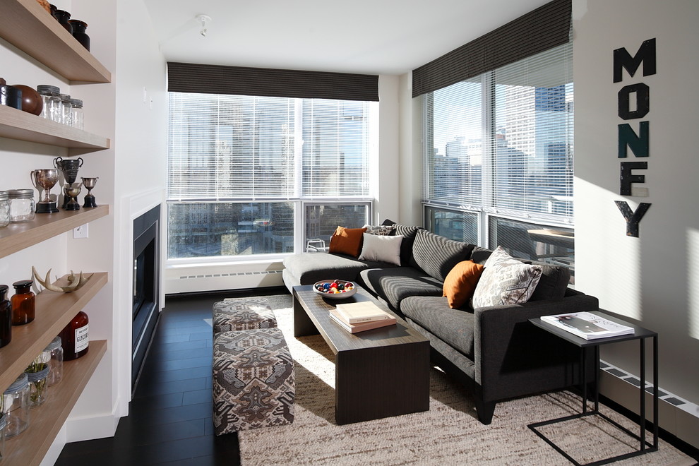 Living room - contemporary dark wood floor and black floor living room idea in Calgary with a standard fireplace