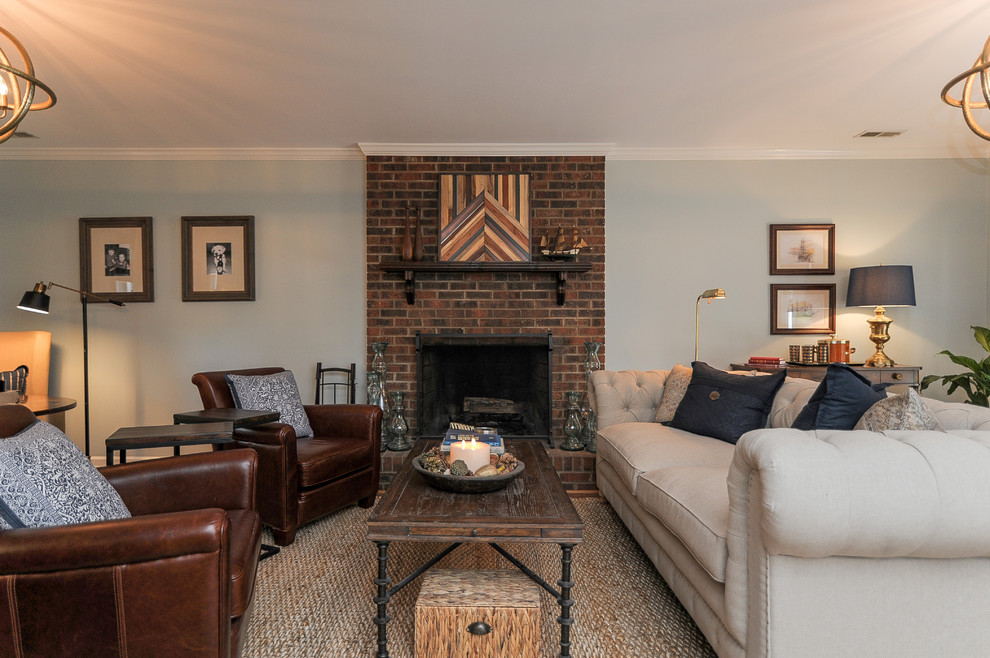 Réalisation d'un grand salon tradition ouvert avec un mur bleu, un sol en bois brun, une cheminée standard, un manteau de cheminée en brique et aucun téléviseur.