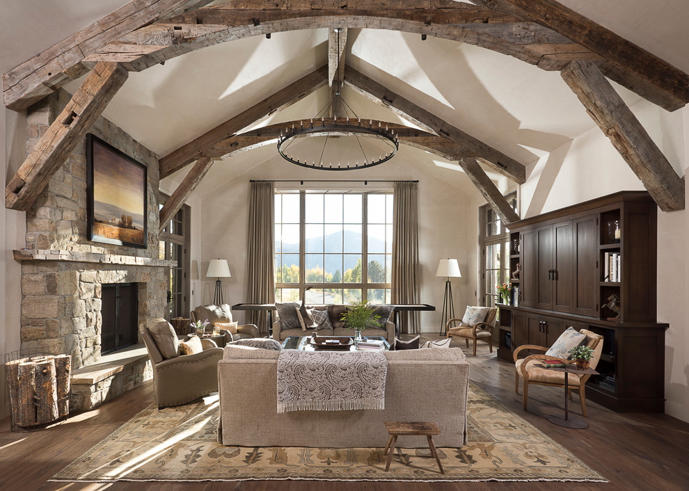 Mountain style dark wood floor living room photo in Other with white walls, a standard fireplace and a stone fireplace