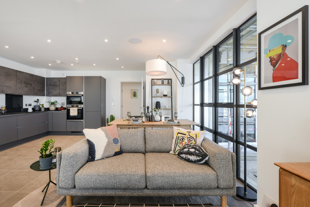 Example of an eclectic concrete floor and gray floor living room design in London with white walls