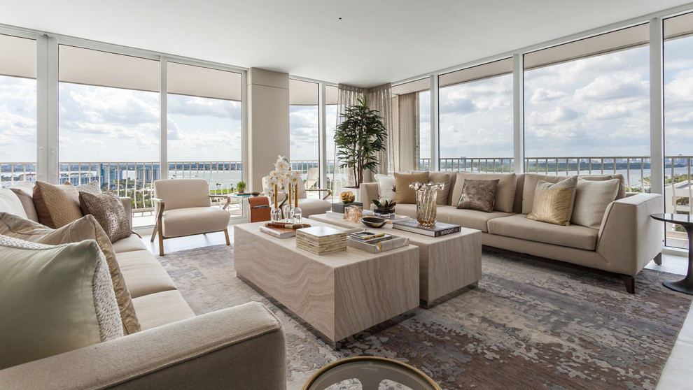This is an example of a large contemporary formal open plan living room in Miami with beige walls, porcelain flooring, no fireplace, no tv and beige floors.