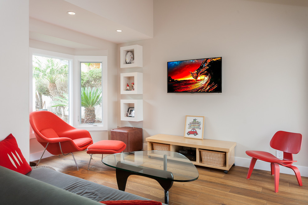 Contemporary living room in Orange County with white walls, no fireplace and a wall mounted tv.