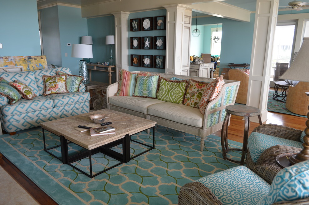 This is an example of a nautical living room in Other with blue walls and medium hardwood flooring.