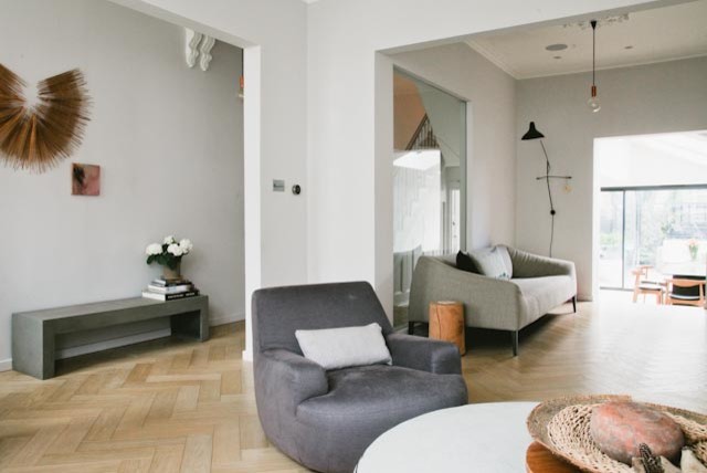 Foto di un ampio soggiorno design chiuso con sala formale, pareti bianche, parquet chiaro, camino classico, cornice del camino in pietra e TV a parete