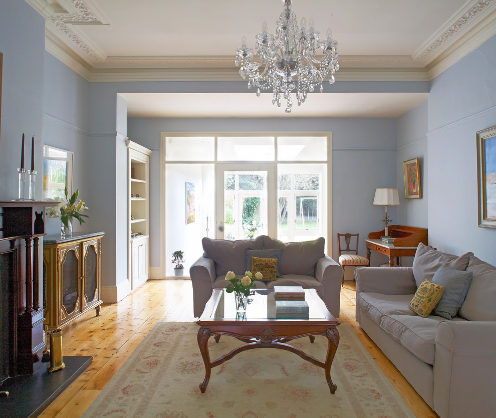 Imagen de salón clásico con paredes grises y suelo de madera en tonos medios