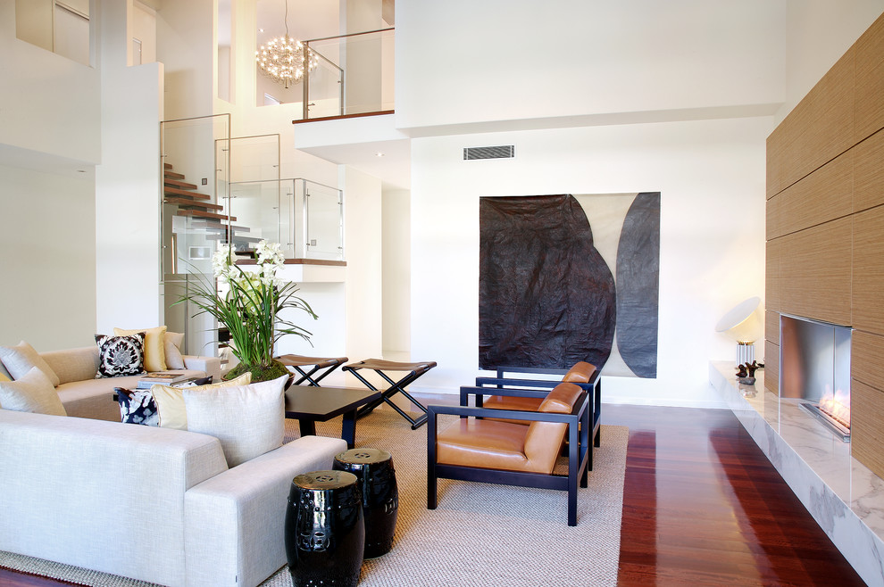 Example of a large trendy open concept dark wood floor living room design in Brisbane with white walls and a ribbon fireplace