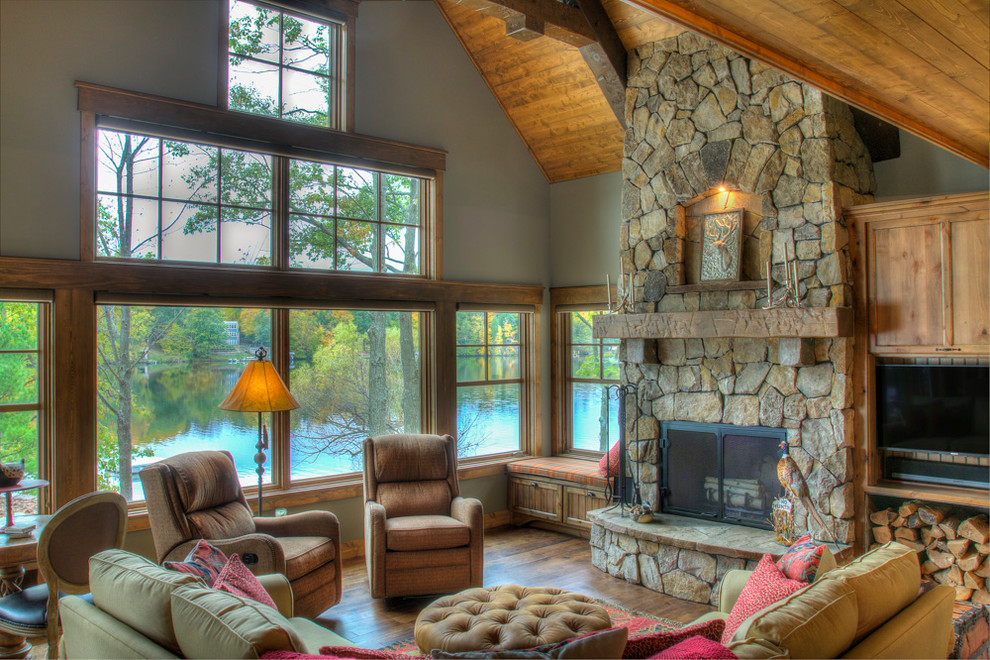 Example of a large mountain style formal and enclosed dark wood floor and brown floor living room design in Minneapolis with gray walls, a standard fireplace, a stone fireplace and no tv