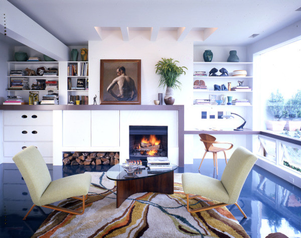 Foto di un soggiorno minimalista stile loft con camino classico e pavimento blu