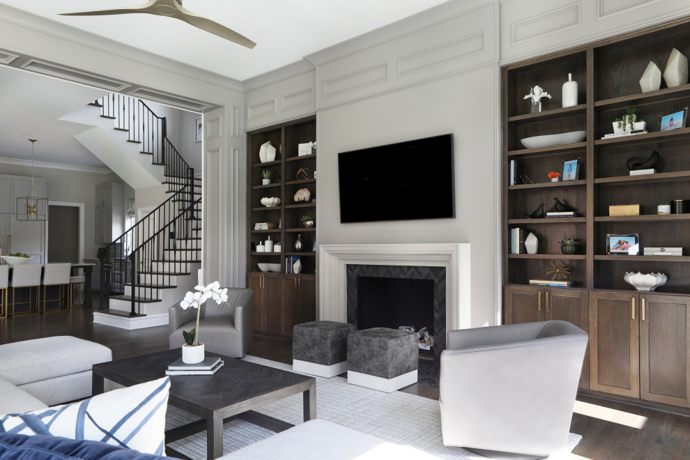 Design ideas for a large traditional open plan living room in Dallas with grey walls, medium hardwood flooring, a standard fireplace, a tiled fireplace surround, a wall mounted tv, brown floors and panelled walls.