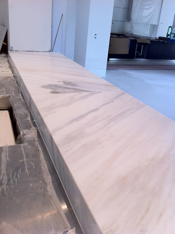bar with suspended counter top book matched calacatta marble