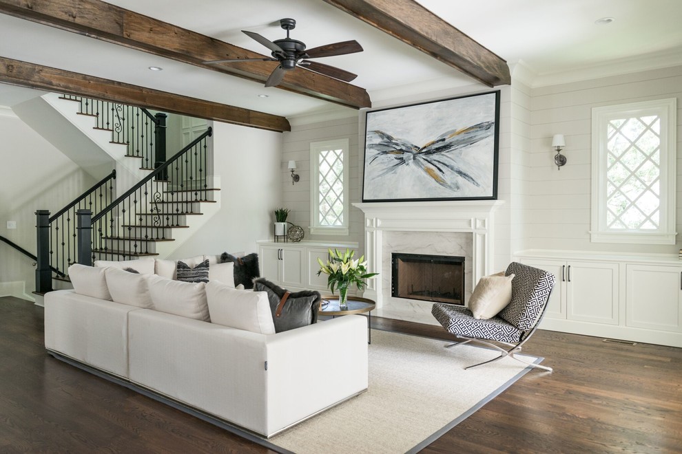 Photo of a traditional living room in Atlanta with white walls, dark hardwood flooring, a standard fireplace and brown floors.