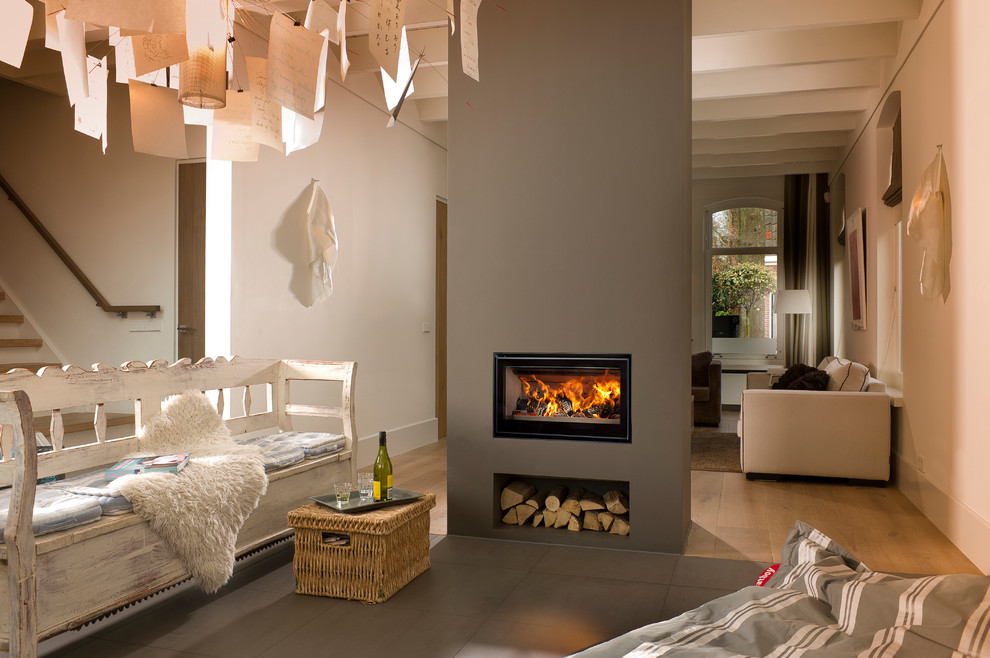 Идея дизайна: гостиная комната с серыми стенами, полом из керамогранита и фасадом камина из штукатурки