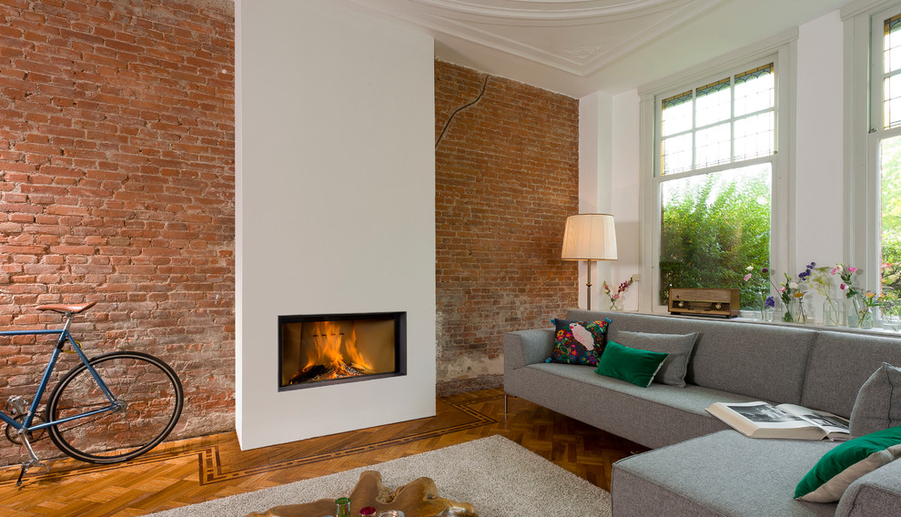 This is an example of a living room in Essex with a hanging fireplace and a stone fireplace surround.