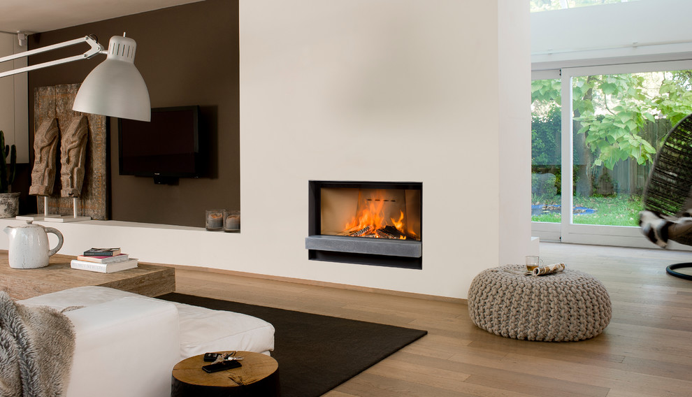 Design ideas for a contemporary living room in Essex with a stone fireplace surround and a ribbon fireplace.