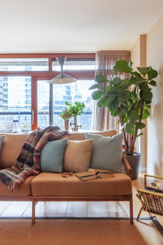 Example of a mid-century modern living room design in London