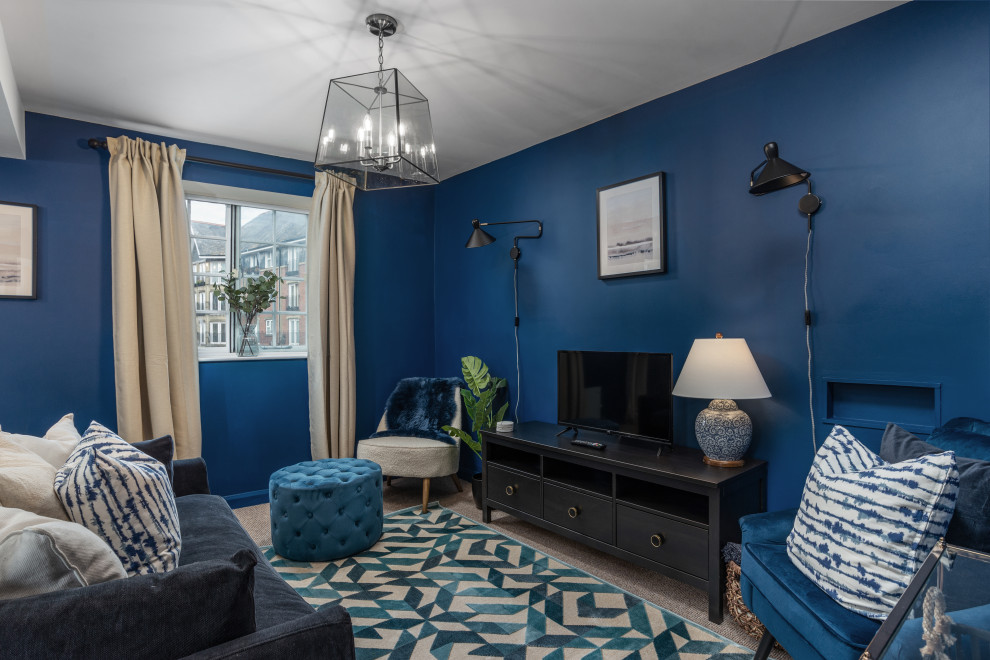 Traditional living room in West Midlands with blue walls, carpet, no fireplace, a freestanding tv and grey floors.