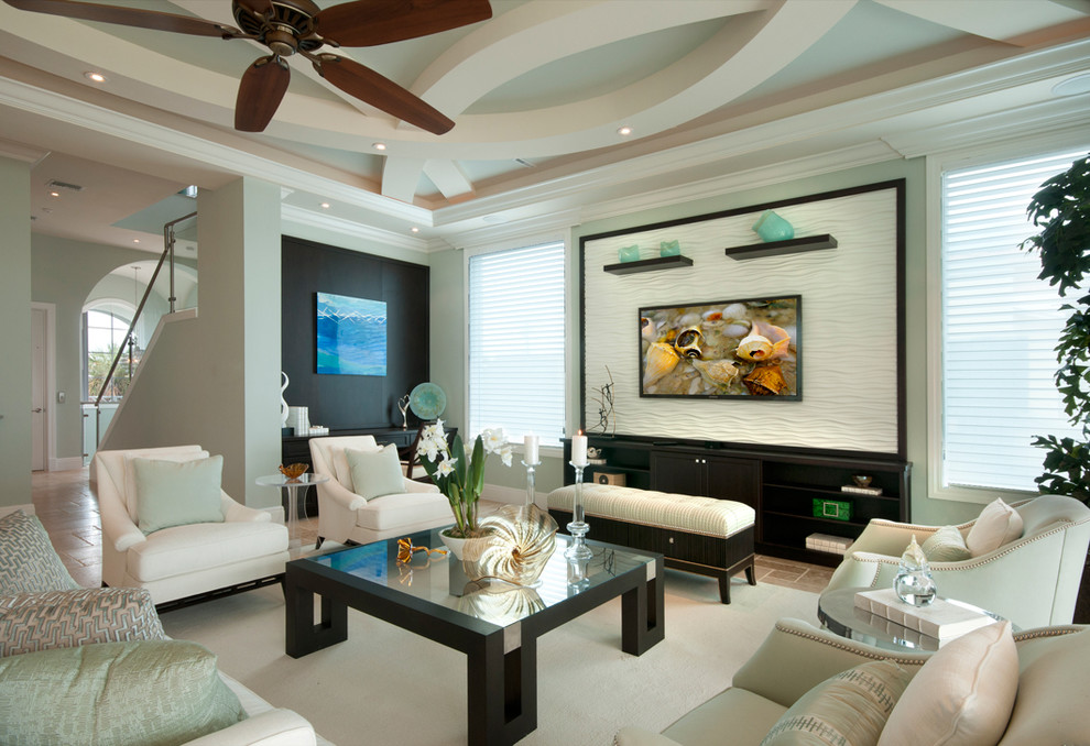 This is an example of a large traditional living room in Miami with green walls, no fireplace and a wall mounted tv.