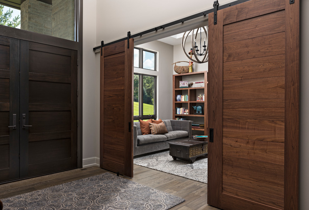 This is an example of a medium sized contemporary formal enclosed living room in Detroit with grey walls, medium hardwood flooring, no fireplace, no tv and brown floors.