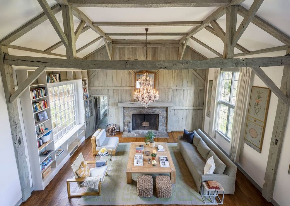 Foto de salón abierto de estilo de casa de campo grande con suelo de madera clara, todas las chimeneas y marco de chimenea de ladrillo