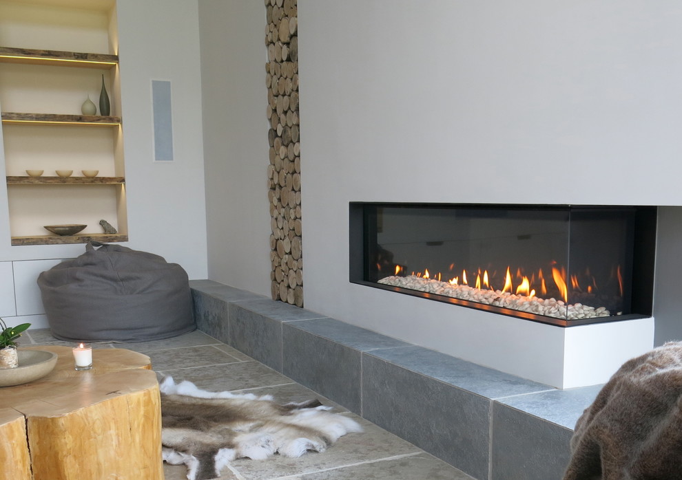 Inspiration for a large contemporary open plan living room in Cheshire with white walls, limestone flooring and a plastered fireplace surround.