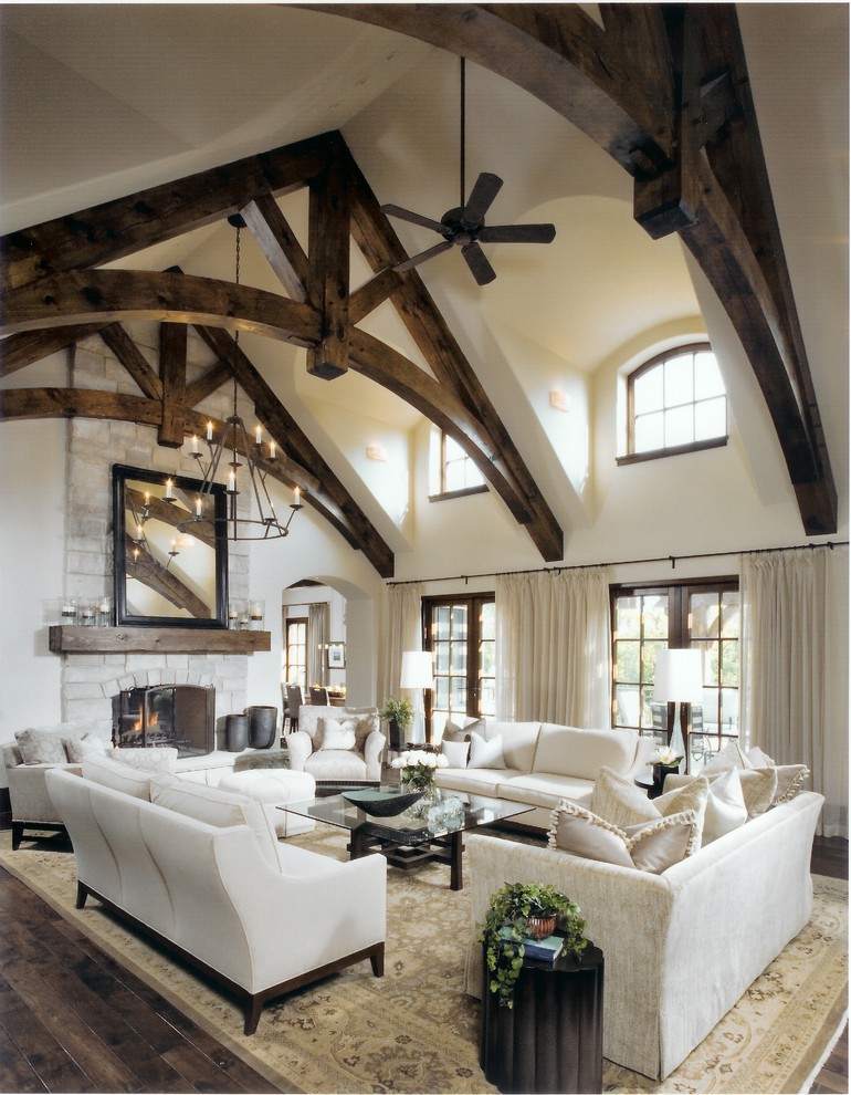 This is an example of a large classic formal enclosed living room in Chicago with beige walls, dark hardwood flooring, a standard fireplace, a stone fireplace surround and brown floors.