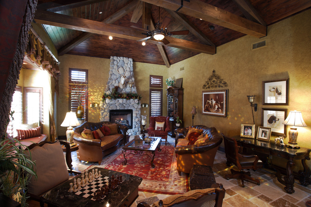 Rustic living room in Other with a stone fireplace surround.