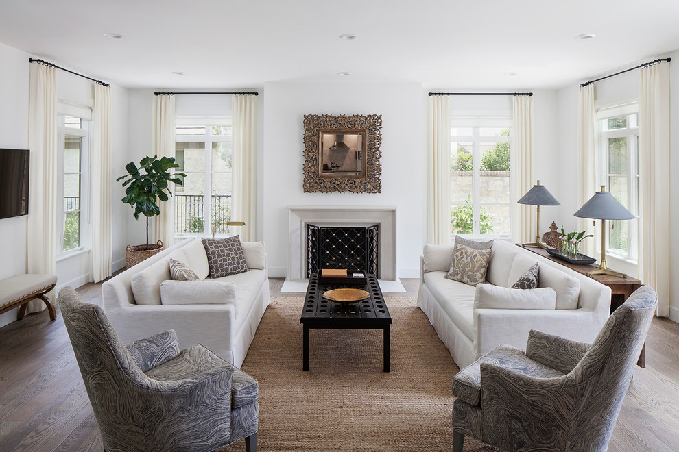 Repräsentatives Klassisches Wohnzimmer mit weißer Wandfarbe, braunem Holzboden und Kamin in Austin