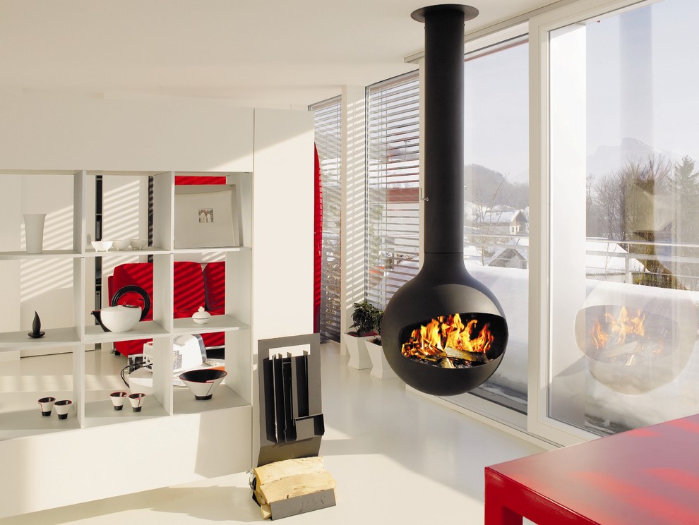 Trendy living room photo in Devon with white walls and a hanging fireplace