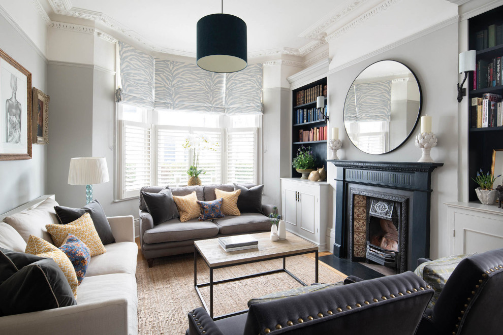 Inspiration for a victorian living room in London with a reading nook, grey walls, a wood burning stove and a tiled fireplace surround.
