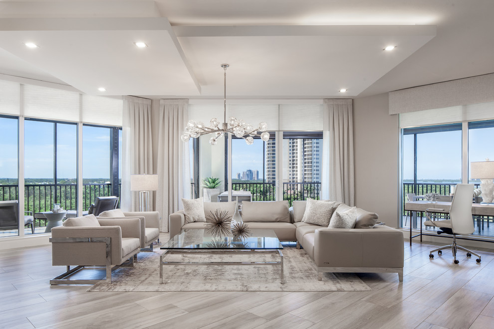 Contemporary formal open plan living room in Other with beige walls, light hardwood flooring and beige floors.