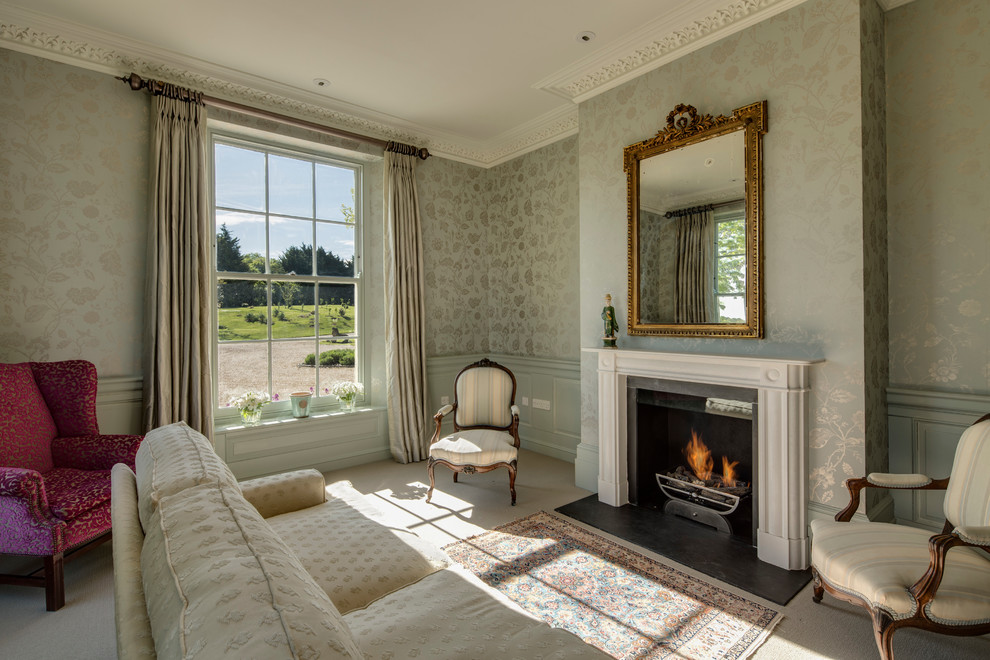 Medium sized classic formal enclosed living room in Hampshire with multi-coloured walls, carpet, a standard fireplace, a stone fireplace surround and no tv.
