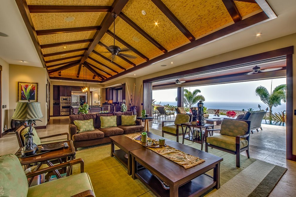 Photo of an expansive world-inspired open plan living room in Hawaii with beige walls, travertine flooring, no fireplace and a built-in media unit.