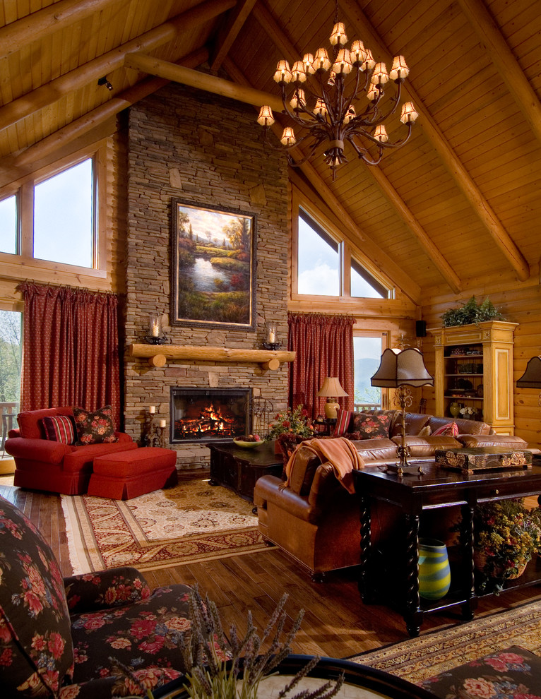 Inspiration for a large rustic formal open plan living room in Huntington with brown walls, medium hardwood flooring, a standard fireplace, a stone fireplace surround, no tv and feature lighting.