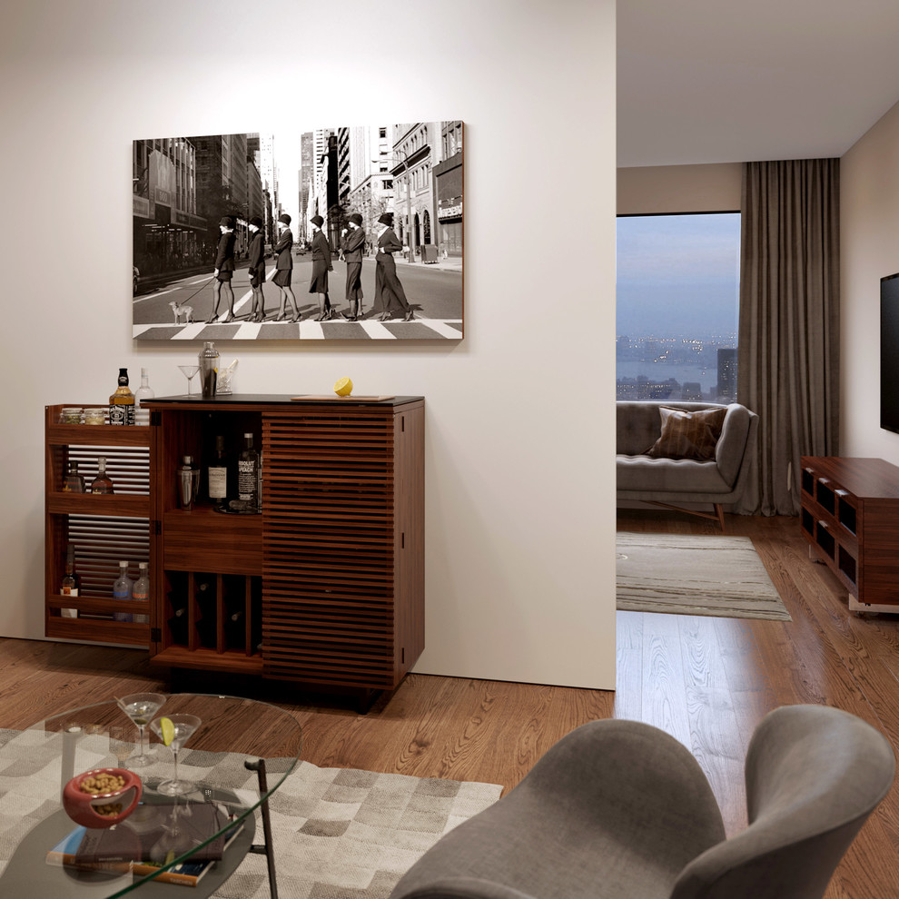 Foto di un soggiorno design chiuso con angolo bar, pareti beige e pavimento in legno massello medio