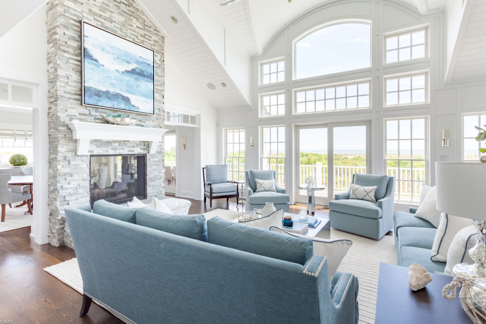 Living room - huge coastal formal and open concept medium tone wood floor and brown floor living room idea in Philadelphia with white walls, a two-sided fireplace, a stone fireplace and no tv