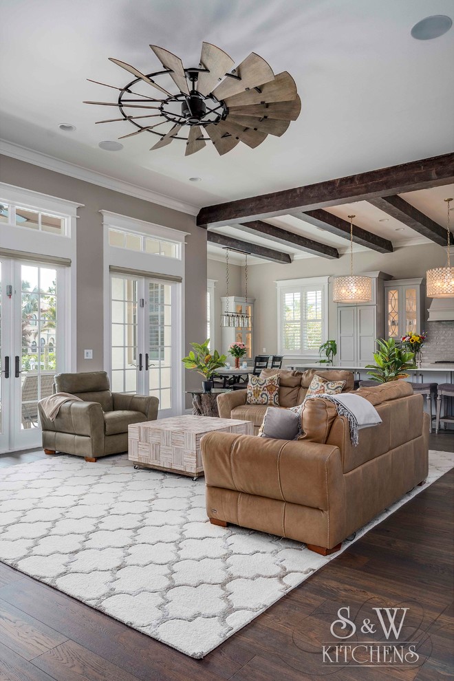 Design ideas for a large nautical open plan living room in Tampa with grey walls, dark hardwood flooring, a standard fireplace, a stone fireplace surround, a wall mounted tv and brown floors.