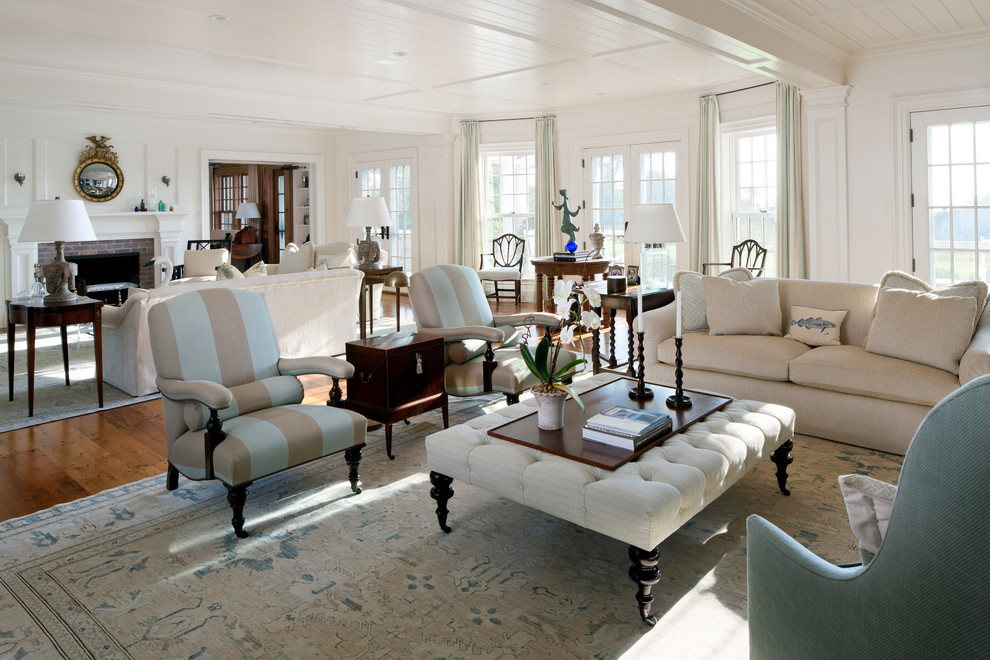 Beach style open concept medium tone wood floor living room photo in Boston with white walls